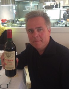 Mike Shelton, an avid wine collector and Pomerol lover, shows off a bottle of Petrus he purchased while traveling in France.